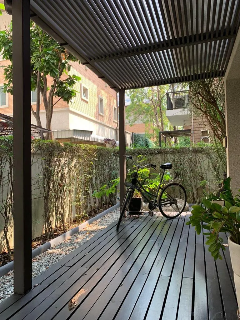 Covered timber deck beside the home's planted garden