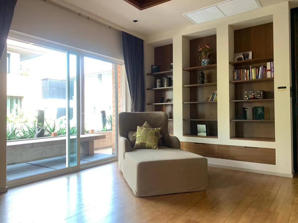 Bedroom reading corner beside built-in display shelves