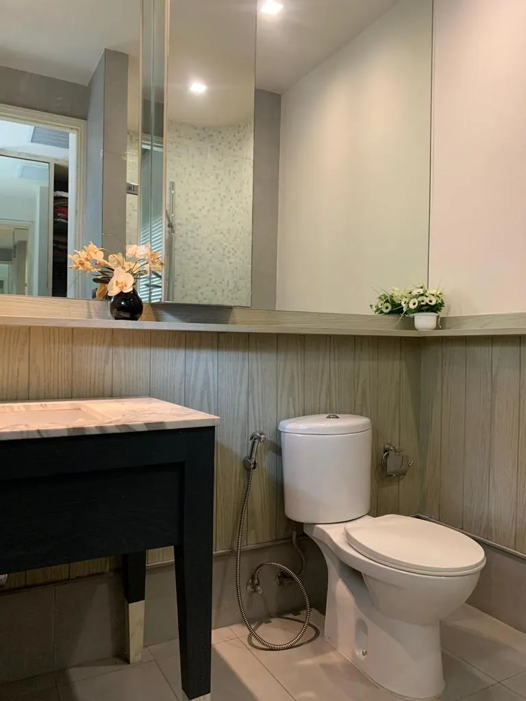 Bathroom with vanity, mirror and fitted storage