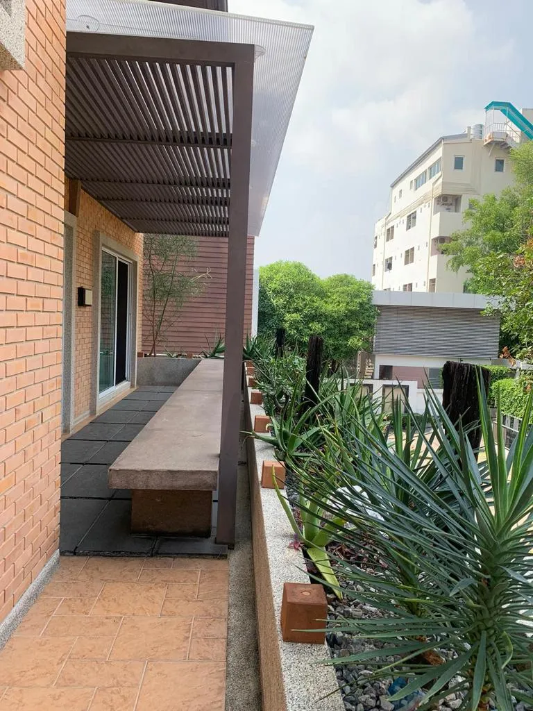 Long planted balcony along the brick facade
