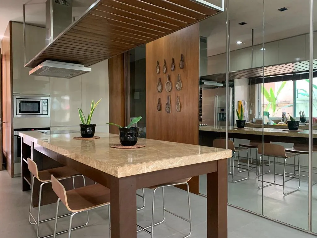 Island kitchen with bar seating and suspended extractor