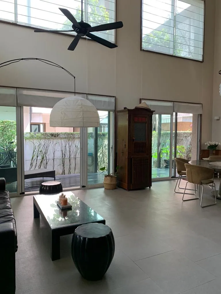 Tall living-room windows and doors opening towards the garden