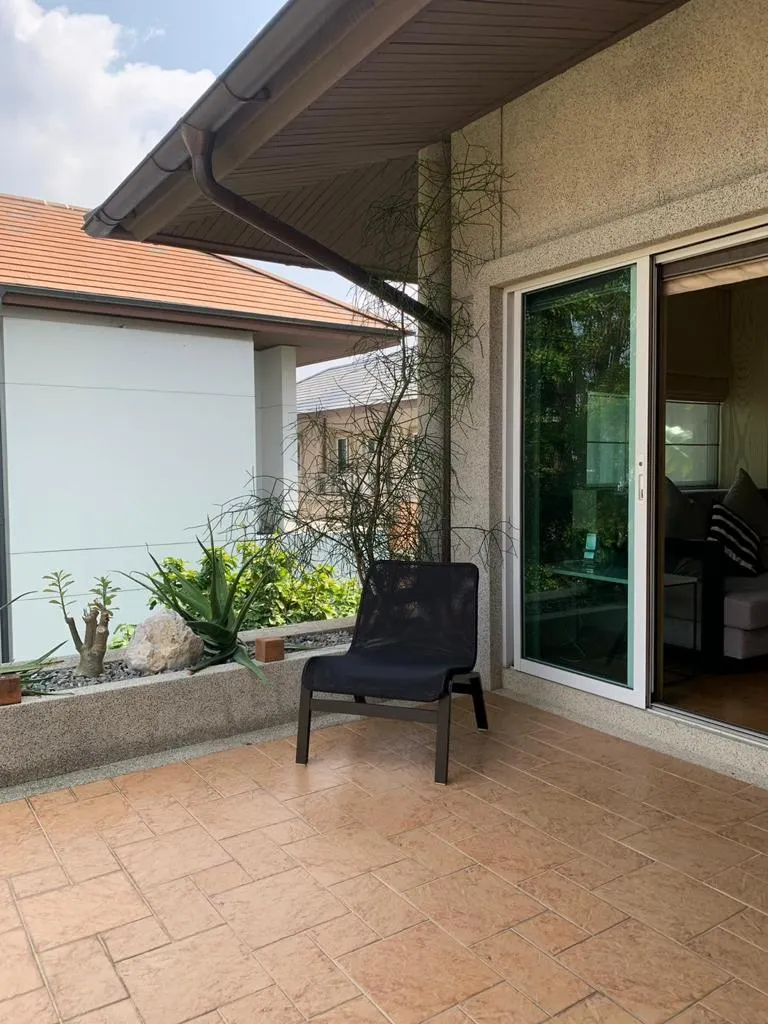 Upper-floor terrace with seating and potted plants