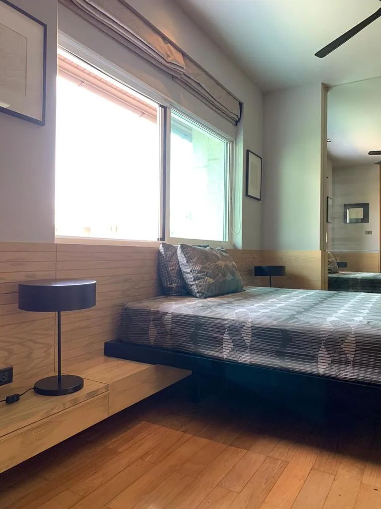 Bedroom with timber flooring and corner windows