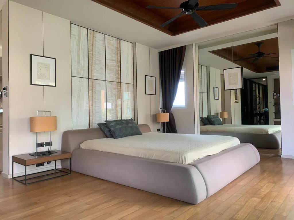 Furnished bedroom with an upholstered bed and fitted wardrobes