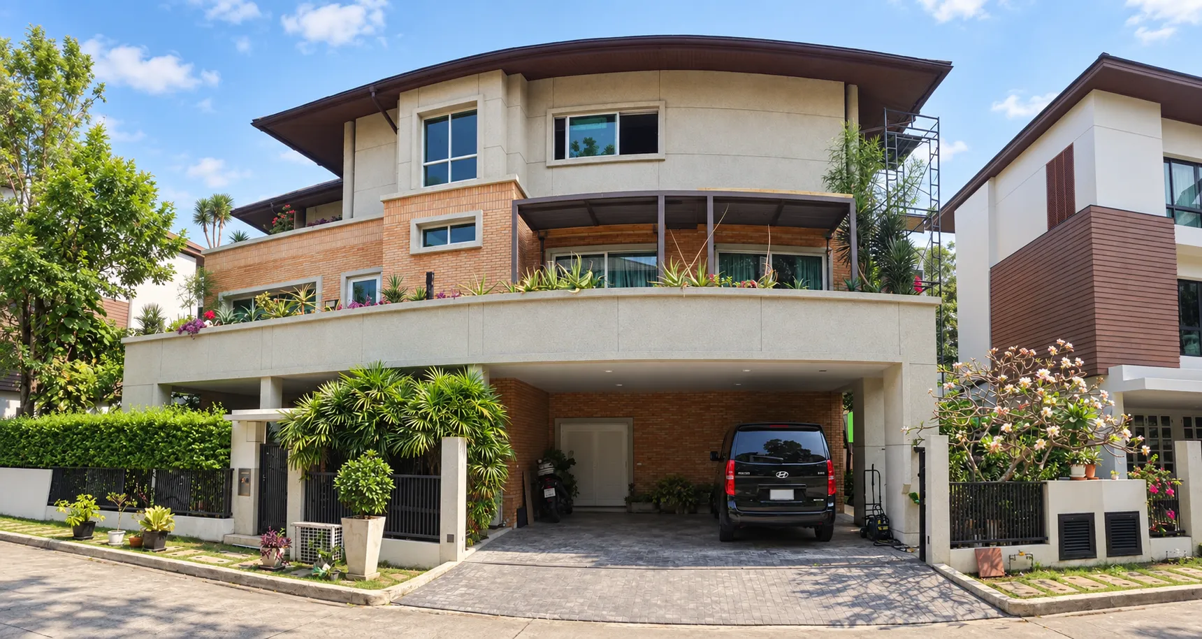 Three-storey house with planted balconies and covered parking at Baan Issara Rama 9