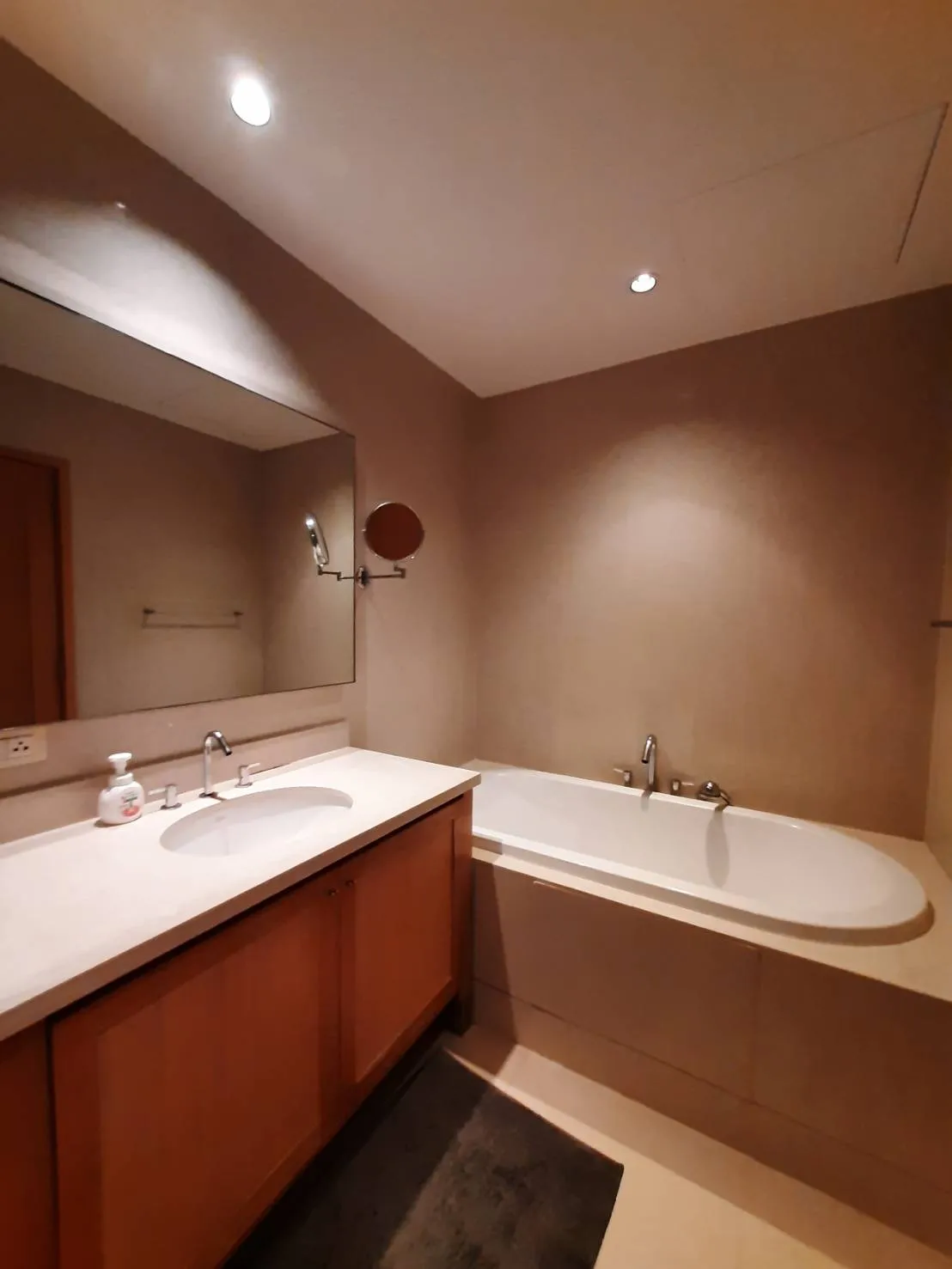 Bathroom with bathtub and long vanity