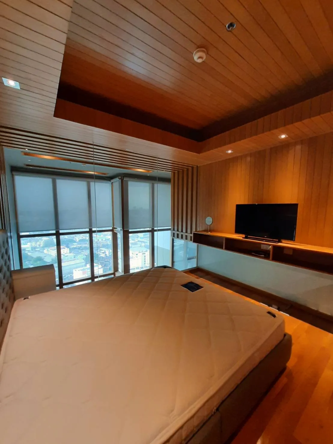 Bedroom with wide city-facing windows