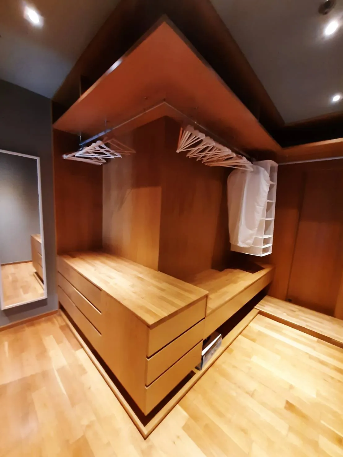 Fitted walk-in wardrobe with timber drawers and rails