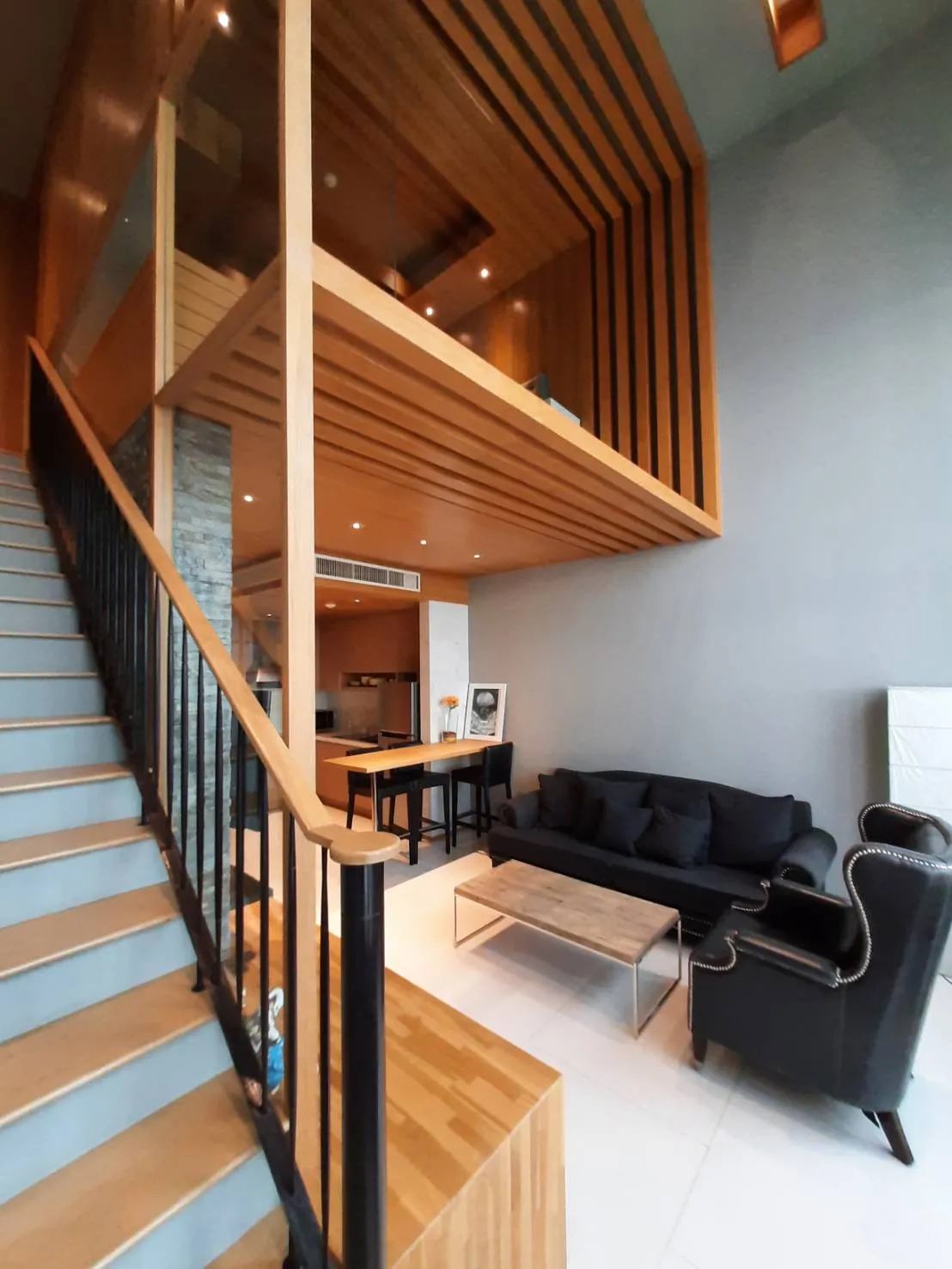 Duplex staircase rising above the living area