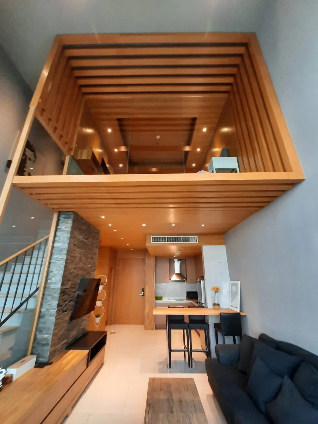 Double-height living room viewed from below the mezzanine