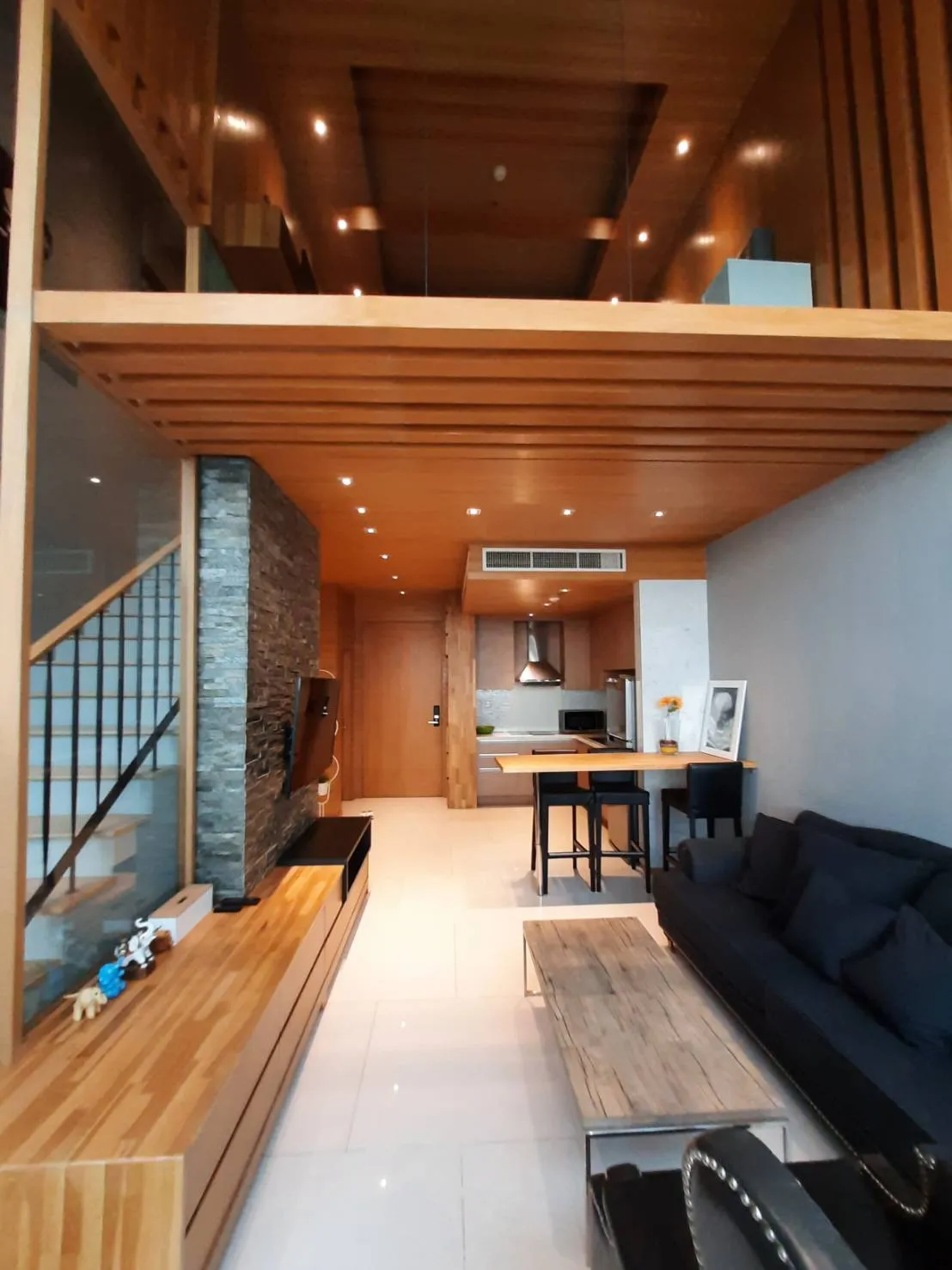 Double-height living room and staircase inside the Emporio Place duplex