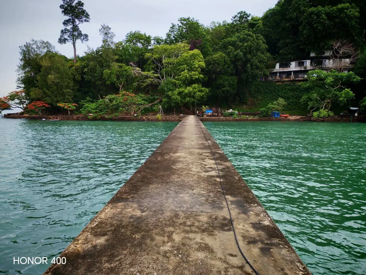 Concrete arrival pier leading to the wooded Koh Tapao Yai estate