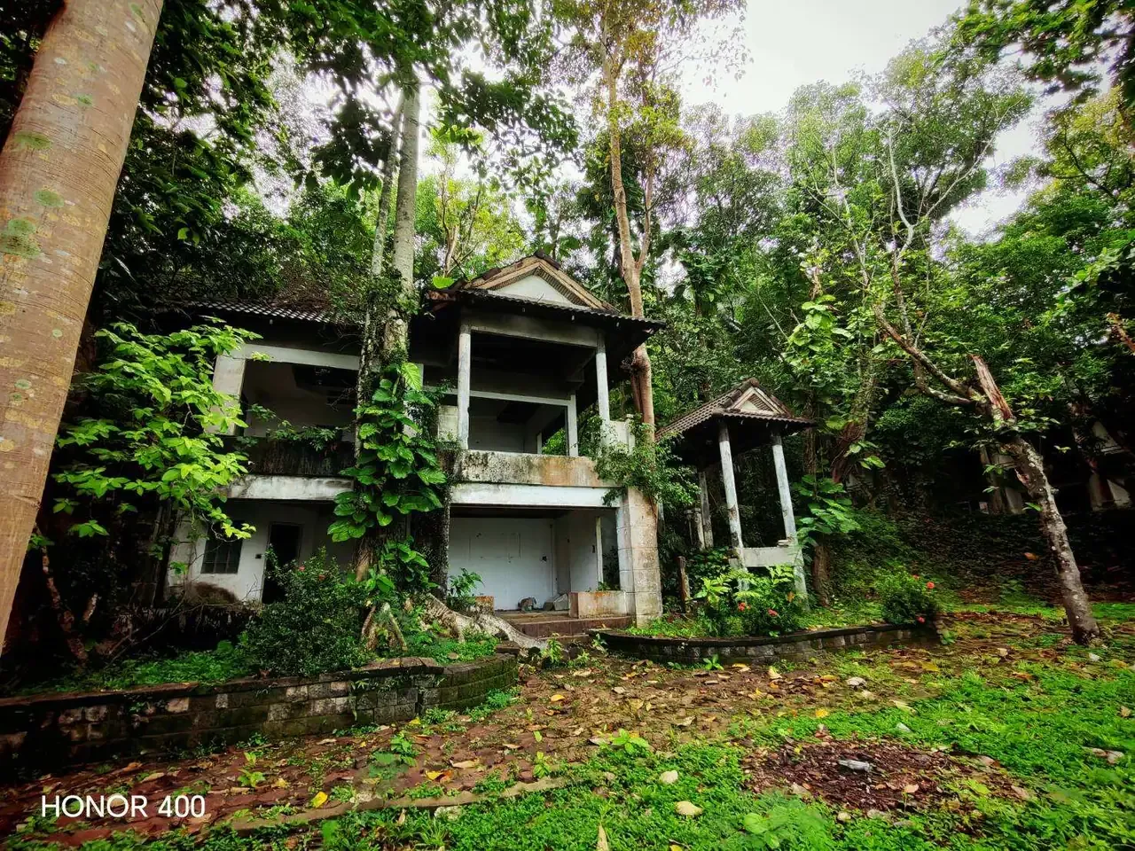 Existing building partly screened by mature trees