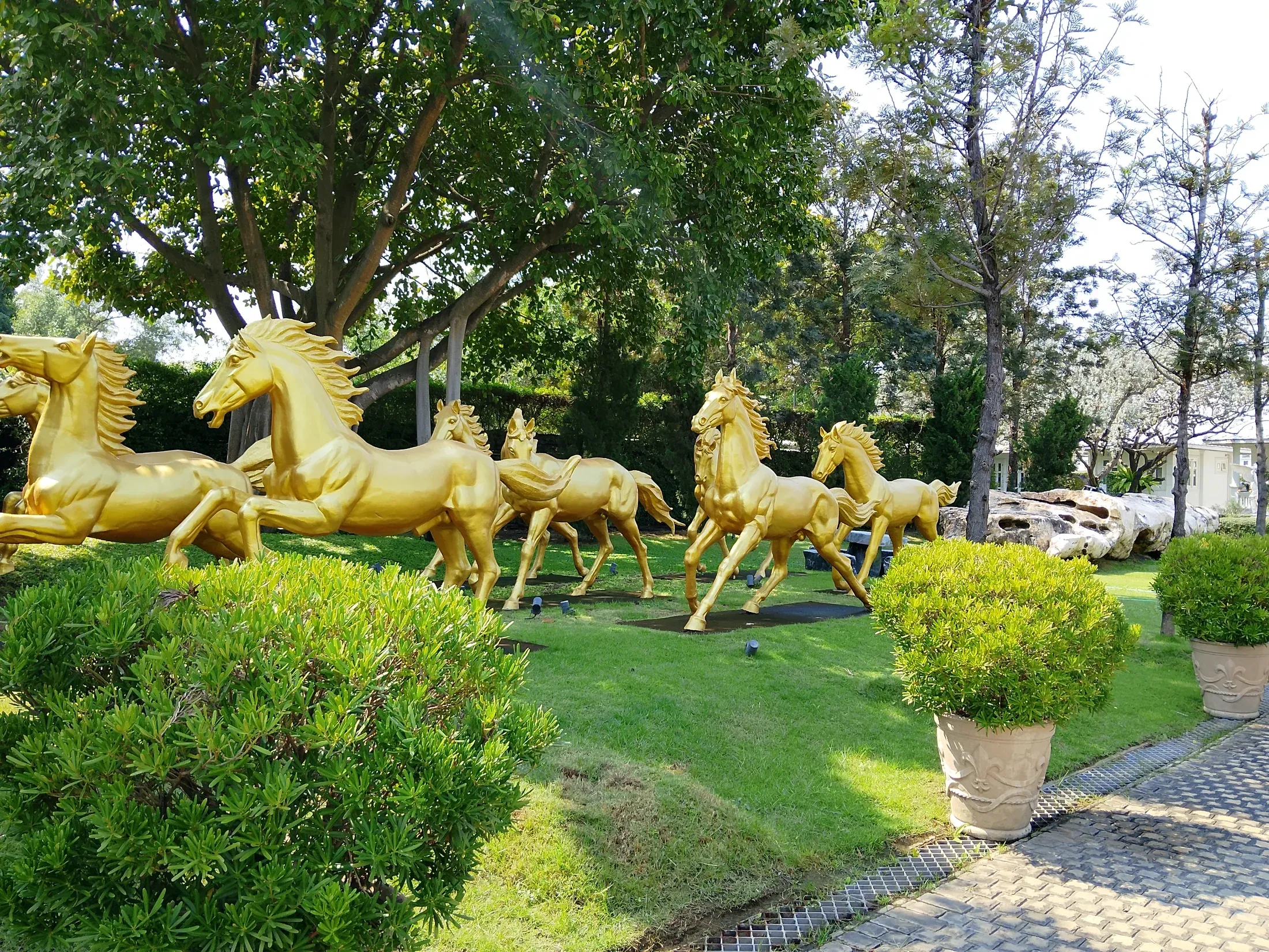 Decorative golden horse sculptures in the garden
