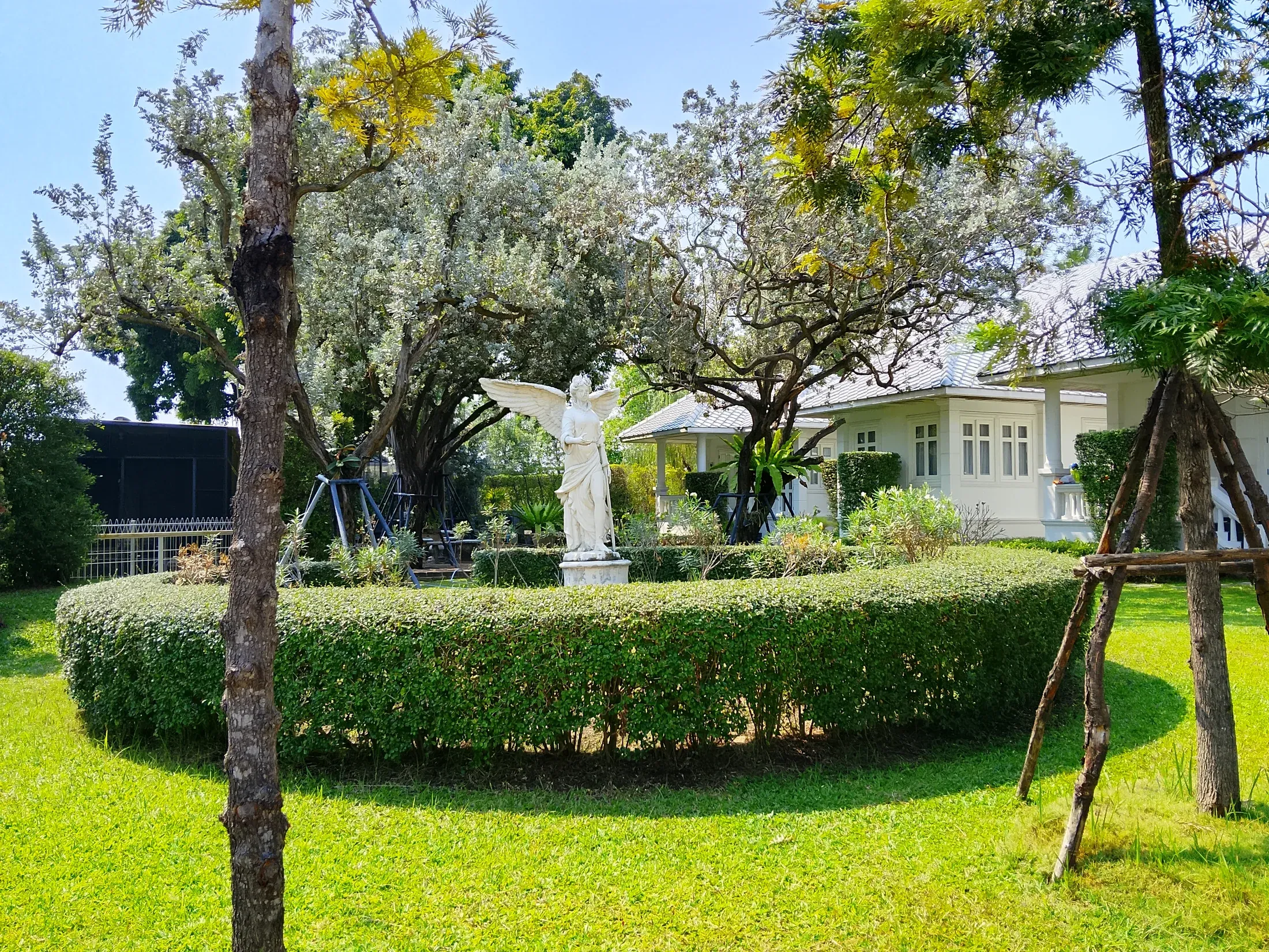 Trimmed lawns and hedges around a guest house