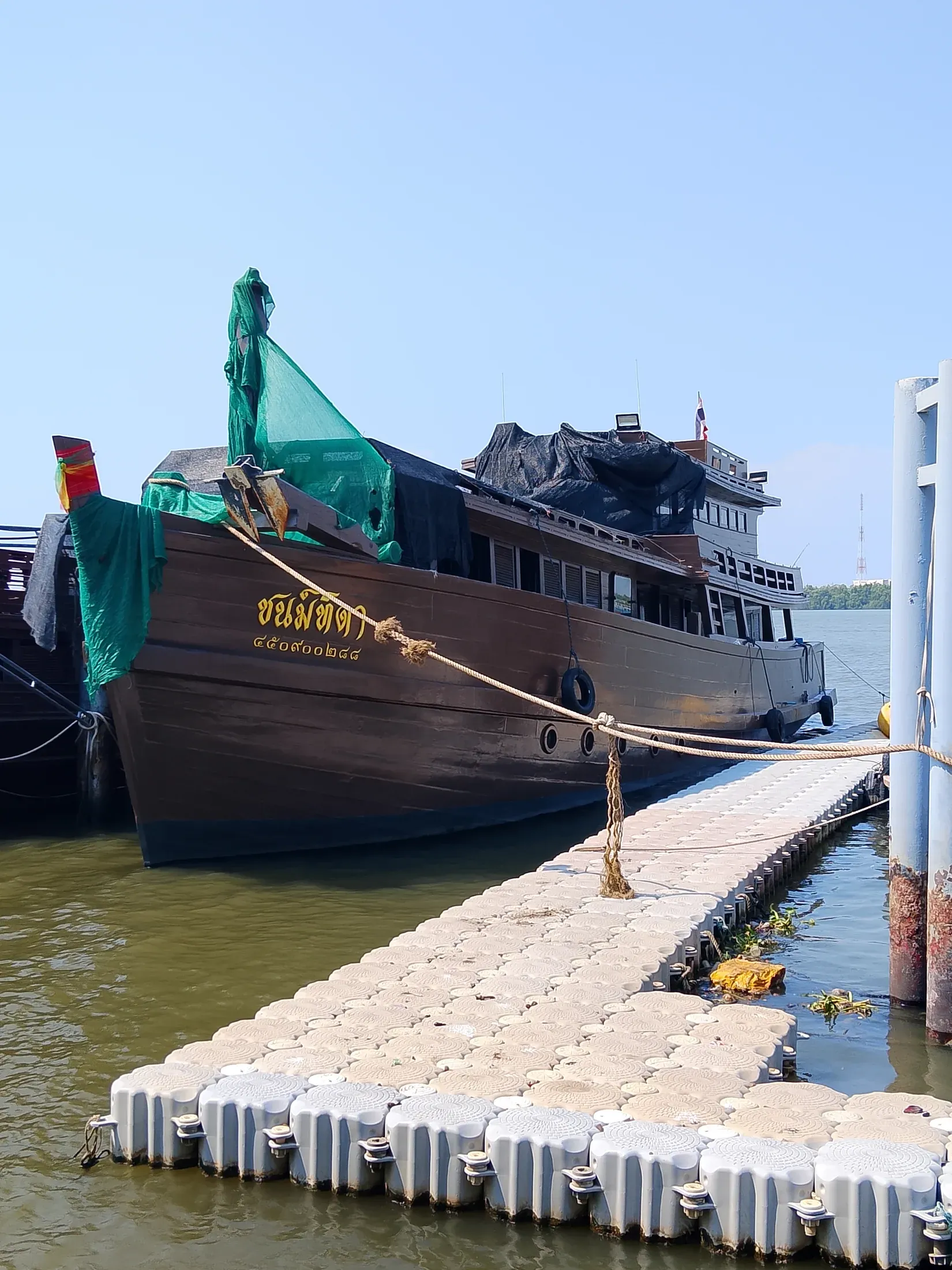 Traditional wooden riverboat moored at the estate