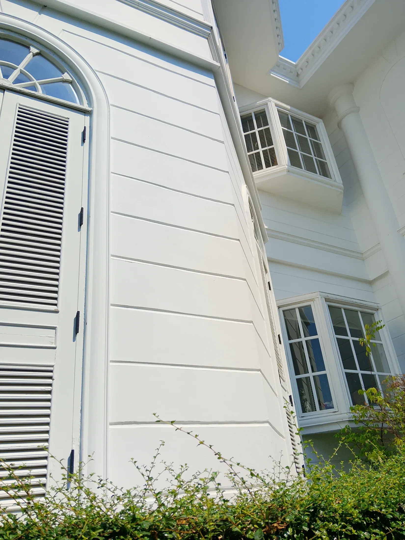 White weatherboard exterior and shutter detail