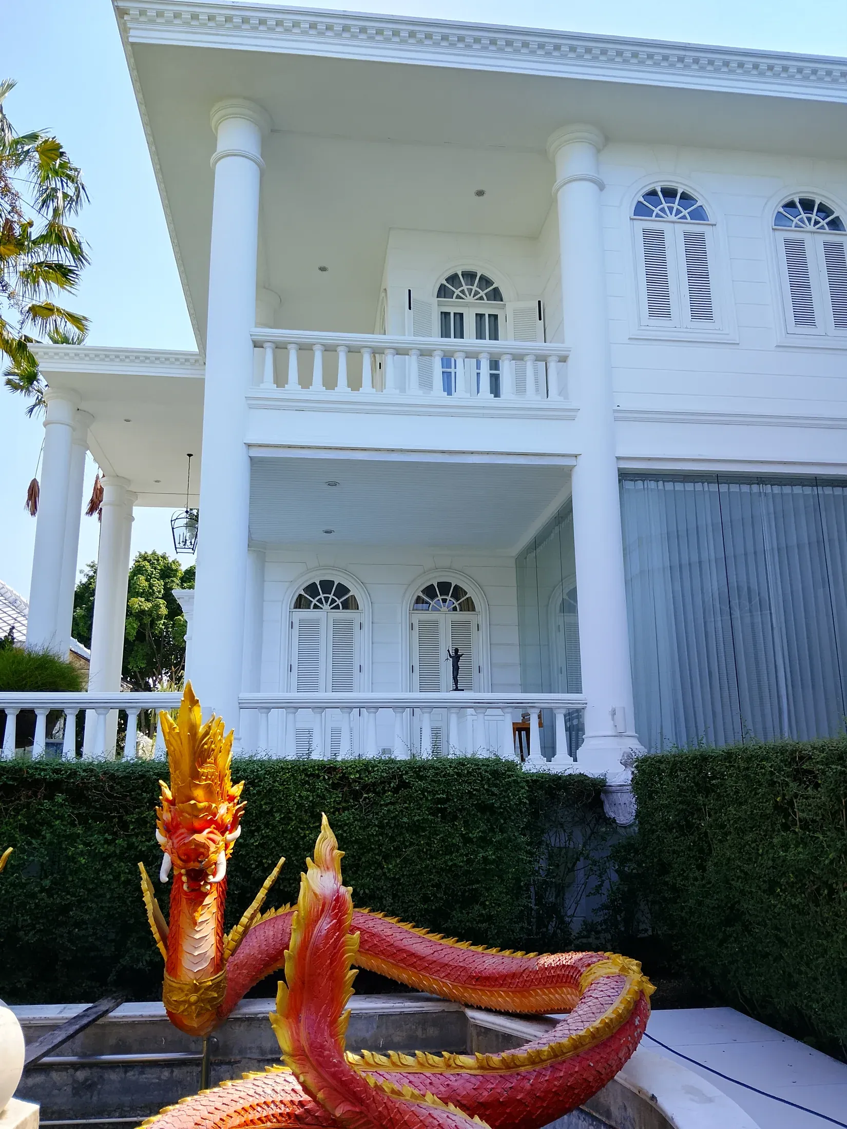 Main residence entrance beneath the upper balcony