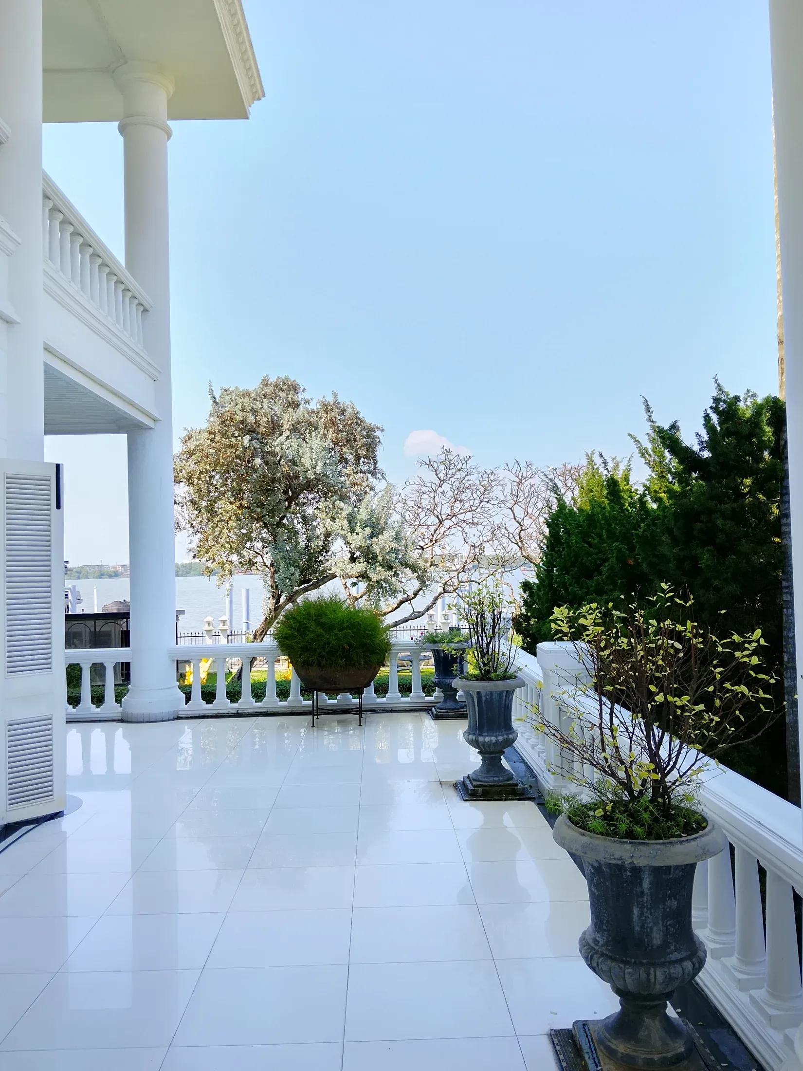 Upper terrace with potted trees and river views